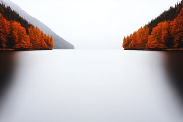 Serene lake reflecting vibrant autumn colors from surrounding tr