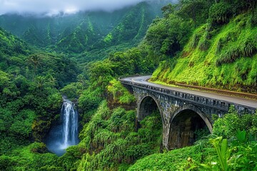 Fototapeta premium Journey Through Hana: Scenic Highway with One-Lane Bridge Beside Waterfall in Lush Maui Rainforest