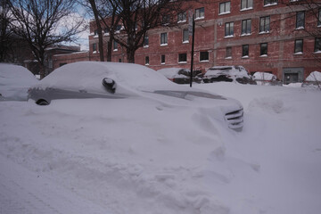 A snow-covered car parked in the street