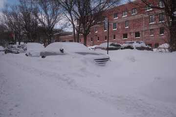 A snow-covered car parked in the street