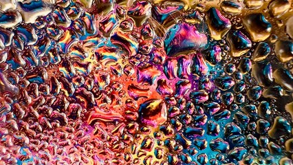 Close-up of water drops on metal surface in high resolution showing condensation of water droplets on metal surface. Intricate patterns and different sized water droplets create a beautiful abstract