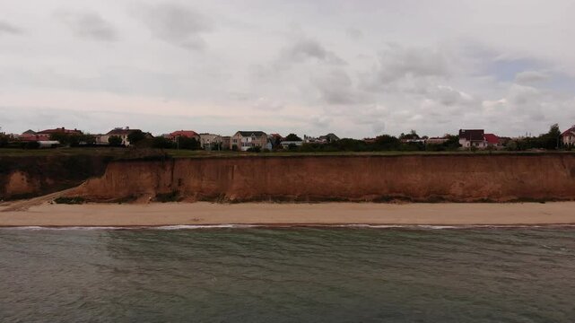 Aerial Drone View on Sandy Beach, High Cliff, Light Sea Waves in Summer Day