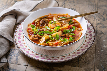 Healthy cabbage soup with meatballs, mushrooms and green onions, sauerkraut soup