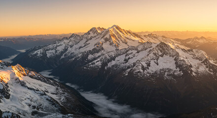Golden Sunrise Over Snowy Mountain Range