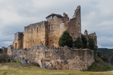 Ancient Templar castle ruins in Ucero, Spain, under a dramatic sky