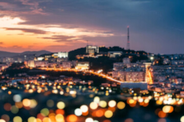 The lights of the night city. Blurred background. Lanterns on the street. big city lights in the twilight evening with blurring. Colorful circles of light abstract. circular bokeh on blue horizon.