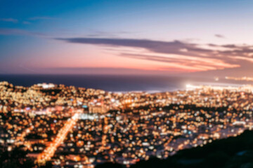 Fototapeta premium The lights of the night city. Blurred background. Lanterns on the street. big city lights in the twilight evening with blurring. Colorful circles of light abstract. circular bokeh on blue horizon.