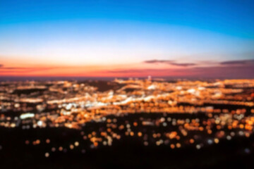 Fototapeta premium The lights of the night city. Blurred background. Lanterns on the street. big city lights in the twilight evening with blurring. Colorful circles of light abstract. circular bokeh on blue horizon.