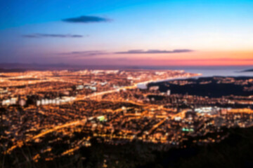 The lights of the night city. Blurred background. Lanterns on the street. big city lights in the twilight evening with blurring. Colorful circles of light abstract. circular bokeh on blue horizon.