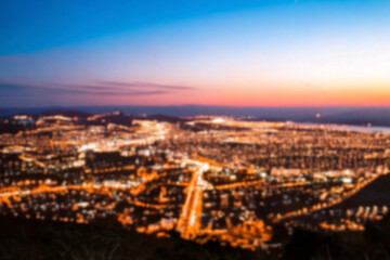 Obraz premium The lights of the night city. Blurred background. Lanterns on the street. big city lights in the twilight evening with blurring. Colorful circles of light abstract. circular bokeh on blue horizon.