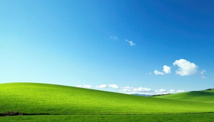 Obraz premium A few thin white clouds drift across the bright blue morning sky, countryside, landscape, blue