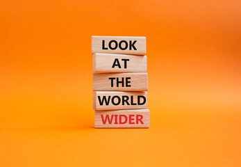 Look at the world wider symbol. Wooden blocks with words Look at the world wider. Beautiful orange background. Business and Look at the world wider concept. Copy space.