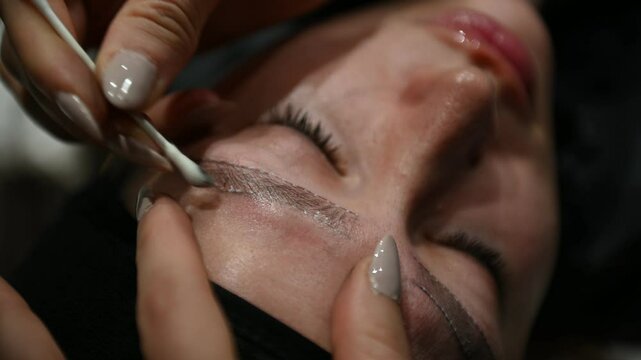 Precise eyebrow microblading procedure with measuring lines for perfect symmetry and shaping