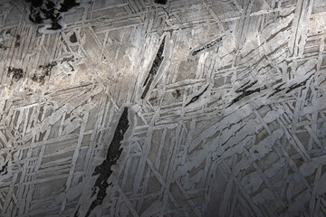 Polished  meteorite surface with chaotic metallic crysal pattern