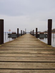 Fototapeta premium Empty wooden pier by calm water