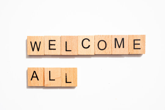 Welcome all in wooden letters on white background