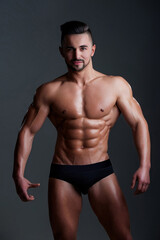 Fototapeta premium Fit man with muscular six pack abs and strong body. Seductive male model with strong power muscles. Attractive topless guy. Young sexy man with muscular body. Sexy male model.