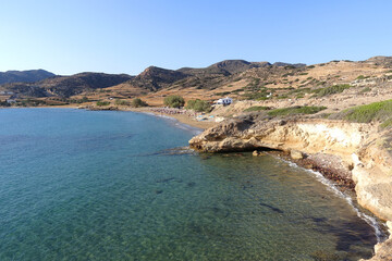 Paradise sandy organised beach of Mavrospilia with white rock formations best place to see the sunset in the island of Kimolos, Cyclades, Greece