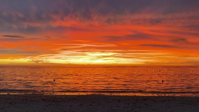  Amazing extraordinary sunset in an orange sky with soft clouds. Colorful sunset. Epic clouds. Bright color. 