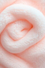 Soft pink fabric arranged in delicate spiral resembling blooming