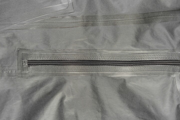 Outerwear fabric. Taped seams of fabric. Waterproof fabric with taped seams. Clothing made of waterproof fabric.