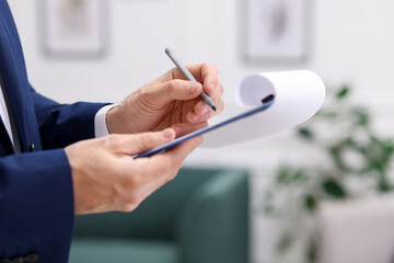 Real estate appraisal. Inspector with clipboard conducting property valuation indoors, closeup