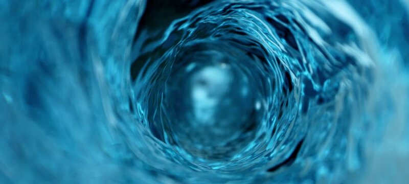 Blue water vortex swirling counterclockwise. A directly above view of blue water spinning anticlockwise and creating a deep vortex