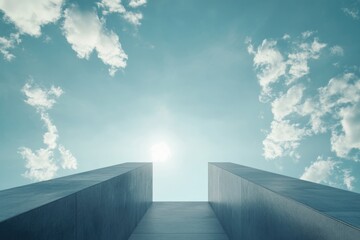 Abstract minimalist architecture with concrete walls reaching towards a bright, cloudy sky.