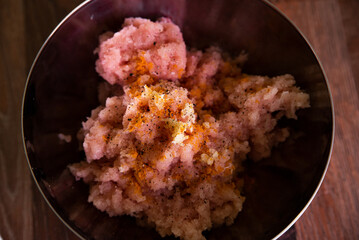 Minced meat with spices in a metal bowl