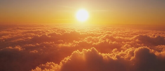 Fototapeta premium A golden sun rises above the clouds, casting warm hues and evoking a sense of grandeur and peace.