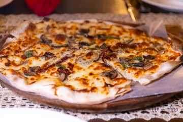 White sauce thin crust pizza with mushrooms