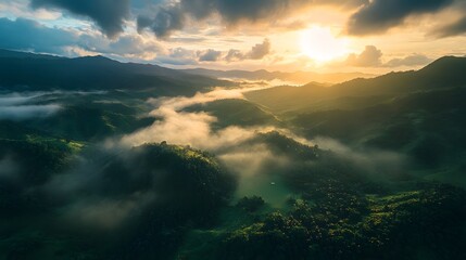 Naklejka premium sunrise mountain range with mist rolling over the landscape