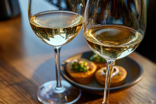 Glass of txakoli or chacol&iacute; slightly sparkling very dry white wine produced in Spanish Basque Country in typical pinchos bar in old part of San Sebastian or Donostia, Spain