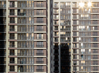 Modern building with glass windows and facade. Skyscraper in the city, reflecting corporate and financial power. Tall, contemporary architecture with residential and commercial properties. Evening