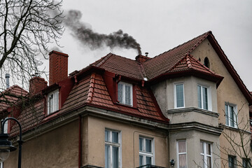 Smoke from the chimney. Winter heating with coal and air pollution