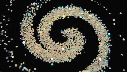 Glitters swirl into a spiral on a black background
