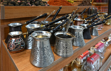 Different types of traditional Turkish coffee pots called cezve on a stall at a shop in stanbul Turkey