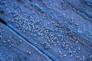 frost on wooden surface with close-up details.