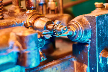 Precision crafting of a clockwork pinion shaft using a milling machine in a vintage workshop setting