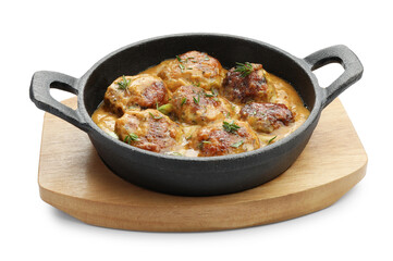 Delicious meatballs with gravy cream sauce and herbs isolated on white