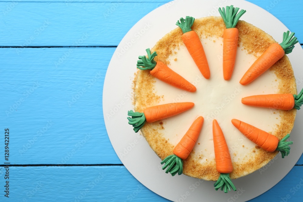 Poster Delicious homemade carrot cake on light blue wooden table, top view. Space for text