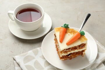 Piece of delicious homemade carrot cake served on light grey table