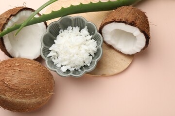Hair treatment. Coconut, butter shavings and aloe leaves on beige background, flat lay