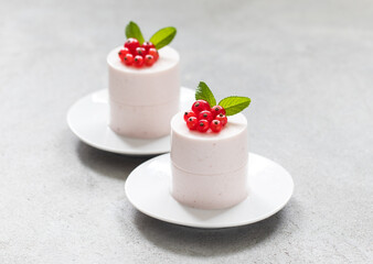Red Currant Cream pudding cylindrical shape. Panna Cotta. On a plate. Close-up