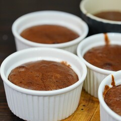 Closeup shot of servings of chocolate creme brulee on a wooden tray