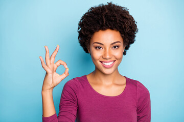 Photo of charming cute nice positive sweet lovely black youth showing you ok sign demonstrating...