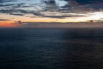 The sky is a beautiful mix of orange and blue hues, creating a serene