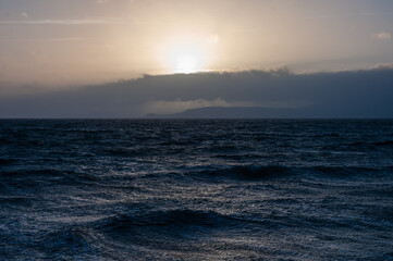 The ocean is calm and the sky is a beautiful shade of blue