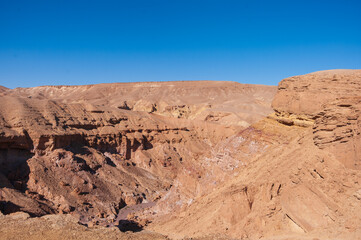 A desert landscape with a blue sky in the background