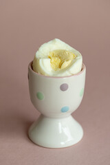 boiled peeled chicken egg in a stand : hard boiled egg for breakfast, egg white and yolk